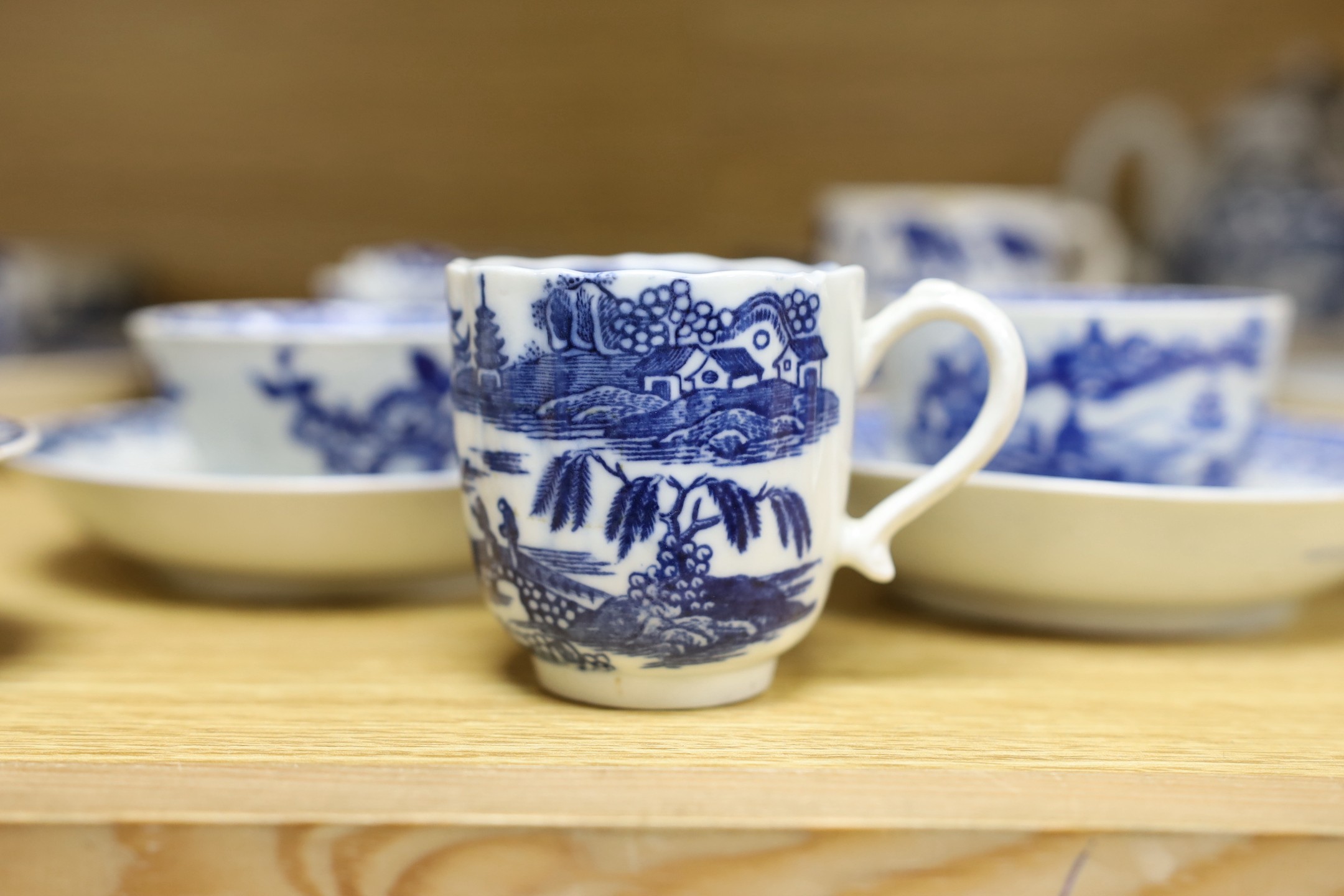 A large group of 18th century Worcester, Caughley and Liverpool blue and white tea bowls, coffee cups and saucers etc. including a Bow Cross-Legged Man